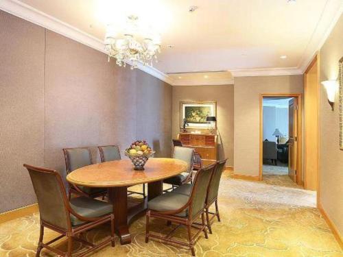 a dining room with a table and chairs at Regency Hotel in Shantou