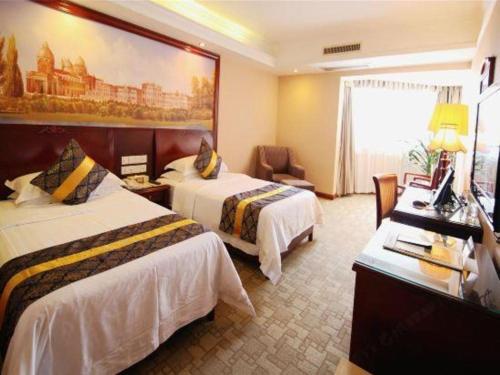 Letto o letti in una camera di Vienna Hotel Nanning Train Station
