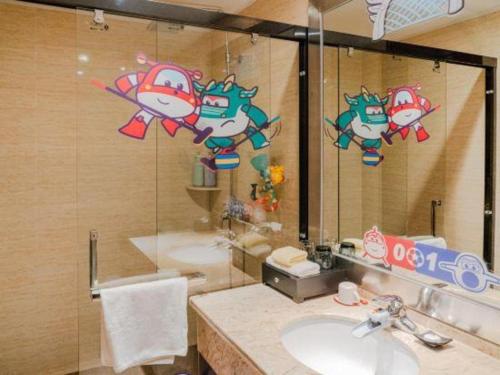 a bathroom with a sink and a large mirror at SUN Yat-sen university Hotel and Conference Centre in Guangzhou