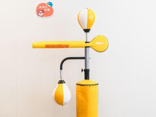 a yellow pitcher and a light on a wall at SUN Yat-sen university Hotel and Conference Centre in Guangzhou