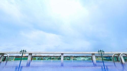 a train station with a bridge in the background at Galaxy Hotel in Jeju