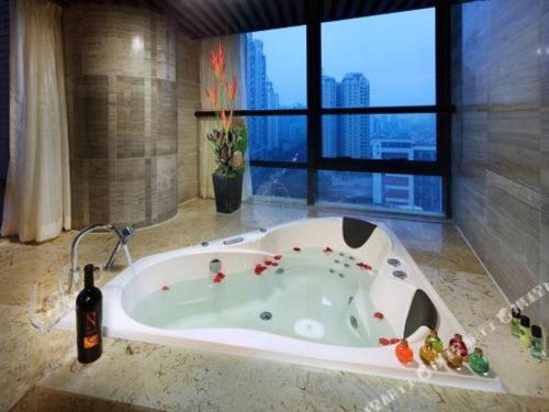 a bath tub in a bathroom with a window at SUN Yat-sen university Hotel and Conference Centre in Guangzhou
