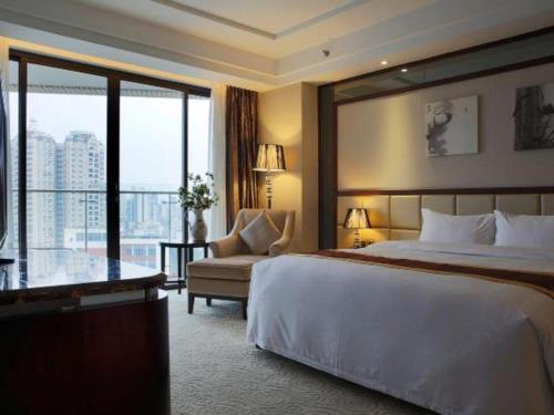 a hotel room with a large bed and a couch at SUN Yat-sen university Hotel and Conference Centre in Guangzhou