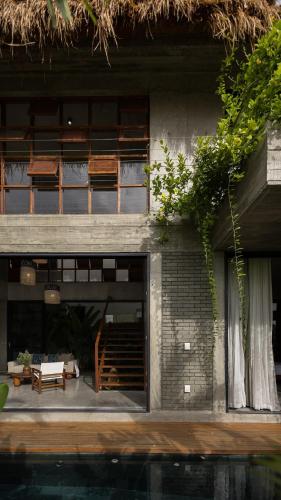 a building with a patio and a staircase in front of it at Private 4 bedrooom Nongnia Beach Villas in Tân Thành (1)