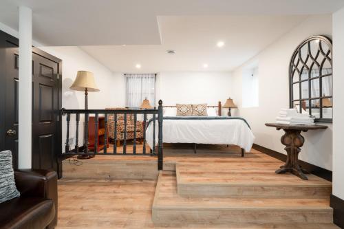 a bedroom with a bed and a table with a lamp at Lyndale Church Lodge in Minneapolis