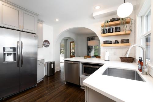 a kitchen with a stainless steel refrigerator and a sink at Fulton Gates in Minneapolis