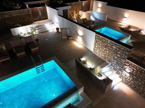 an overhead view of a swimming pool at night at Valantina's & Mannouel Lardos Luxury Villas in Lardos
