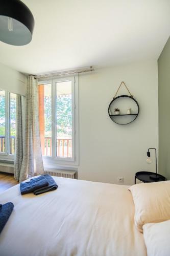une chambre avec un grand lit blanc et une fenêtre dans l'établissement 36 m2 2-room apartment, parking, fiber internet, near metro, Literie Bultex, à Ramonville-Saint-Agne