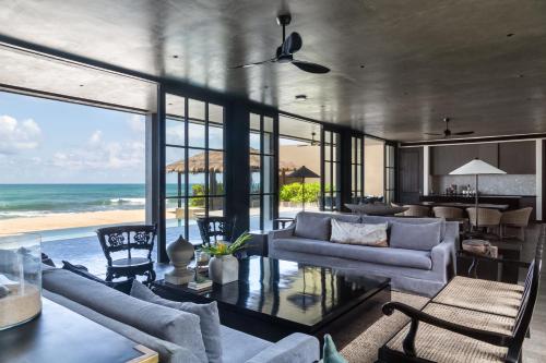 a living room with a view of the ocean at The Six Weligama in Weligama
