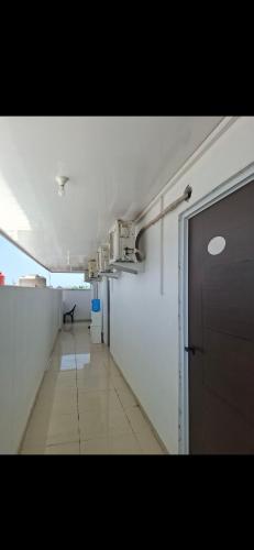 a hallway of an empty room with a door at Hotel Sudut Tidur in Stasiun Tawang