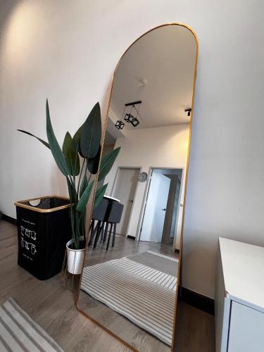 a mirror leaning against a wall in a living room at Urban Nook by MySky Stays at Presint 5 Putrajaya in Putrajaya