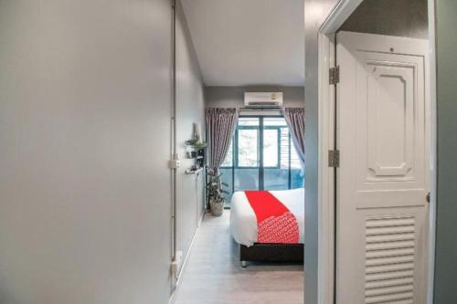 a bedroom with a bed with a red blanket at OYO 726 Sookjai Cafe and Hostel in Chiang Mai