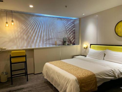 a hotel room with a bed and a large window at Golden Central Hotel Shenzhen in Shenzhen
