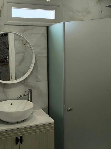 a bathroom with a sink and a mirror at Valantina's & Mannouel Lardos Luxury Villas in Lardos