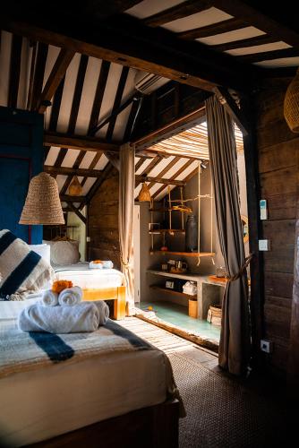 a bedroom with two beds and a fireplace at Amar Boutique Hotel in Canggu