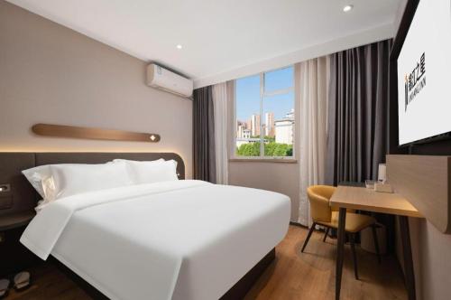 Ένα ή περισσότερα κρεβάτια σε δωμάτιο στο Jinjiang Inn Wuhan Hanjiang Road Metro Station Jiangtan Pedestrian Street