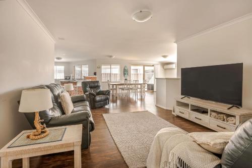 a living room with a large flat screen tv at Spindrift Escape in Dunsborough