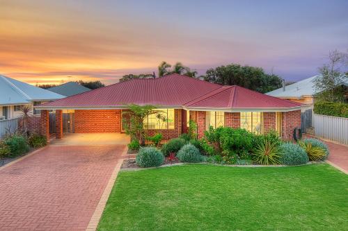 a house with a lawn in front of it at Spindrift Escape in Dunsborough