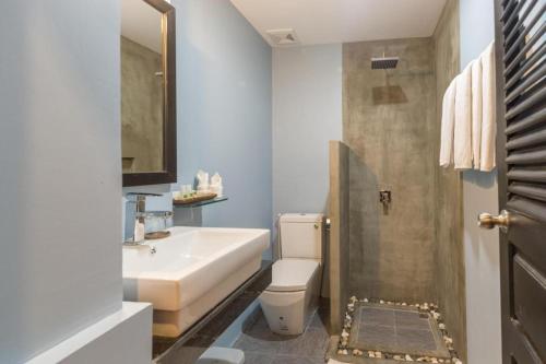a bathroom with a sink and a toilet and a shower at The Cyclo Siem Reap Hotel in Siem Reap