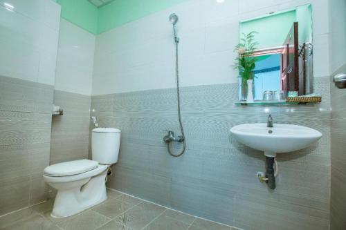 a bathroom with a toilet and a sink at Eden Hotel Sai Gon in Ho Chi Minh City