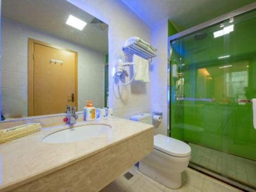 a bathroom with a sink and a toilet and a shower at GreenTree Inn Nantong University Industrial Expo City Express Hotel in Nantong