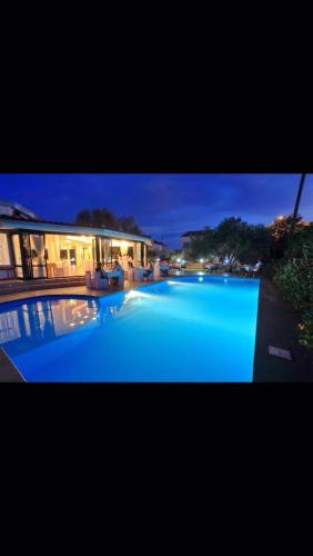 a large blue swimming pool in front of a building at Levant Residence in Sukošan