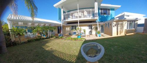 a large house with a yard in front of it at Palm Beach Guest House in Rockingham