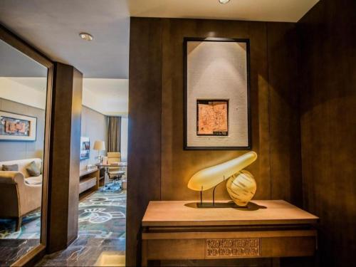 a living room with a table with a yellow lamp at Wuhan Gleetour Hotel in Wuhan