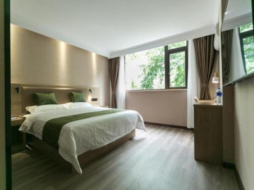 Ένα ή περισσότερα κρεβάτια σε δωμάτιο στο GreenTree Inn Nanjing Railway Station Bus Station Business Hotel