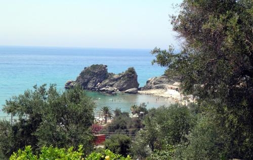 a view of a beach with rocks in the water at Akis Apartments Kontogialos-Pelekas in Pelekas