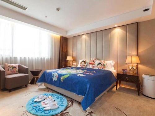 a bedroom with a bed and a couch and a chair at Jinjiang Metropolo Shanghai Minhang in Shanghai