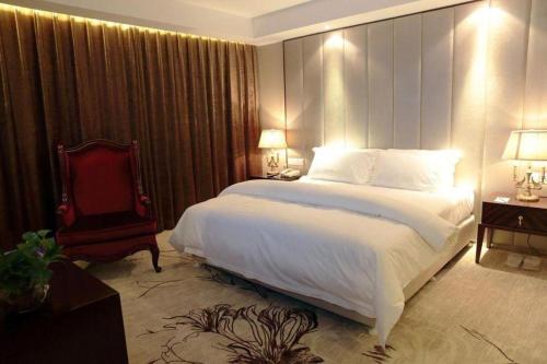 a bedroom with a large bed and a red chair at Jinjiang Metropolo Shanghai Minhang in Shanghai