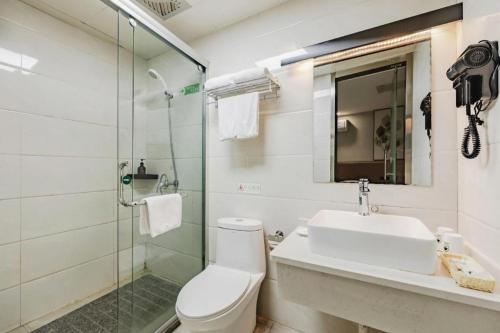 a bathroom with a toilet and a sink and a shower at GreenTree Inn Anqing Renmin Road Commercial Street Express Hotel in Anqing
