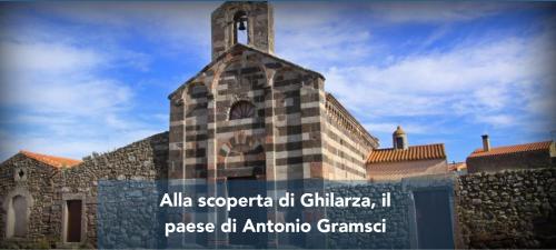 a building with a clock tower on top of it at La casa di nonno in Ghilarza