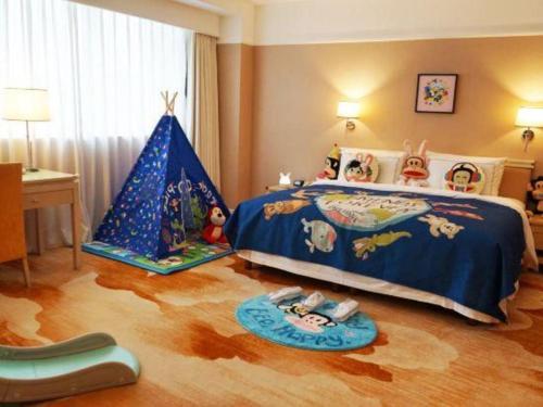 a childs bedroom with a bed and a toy tent at Jianguo Garden Hotel in Beijing