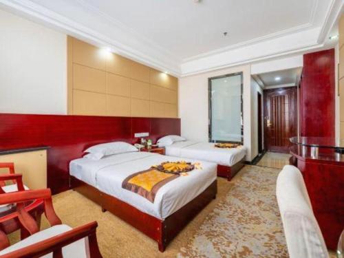 a hotel room with two beds and a chair at Tianrun International Hotel in Dunhuang