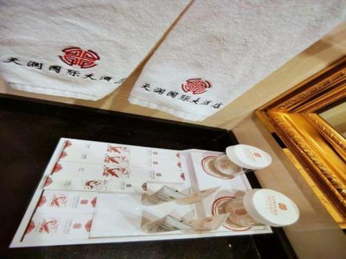 a table with cups and towels on top of it at Tianrun International Hotel in Dunhuang