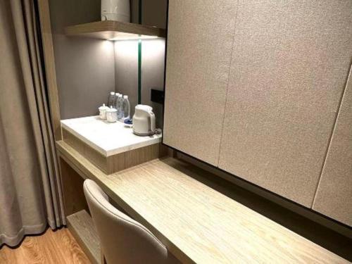 a bathroom with a sink and a mirror at Tianrun International Hotel in Dunhuang