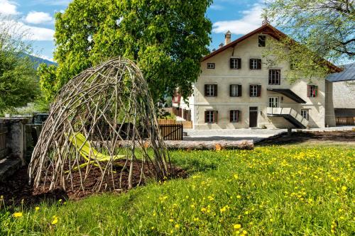 a sculpture in a field in front of a house at Niedermairhof in Brunico