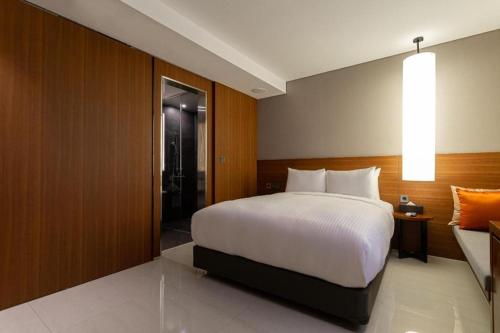 a bedroom with a large bed and a sliding glass door at Top Cloud Hotel Iksan in Iksan