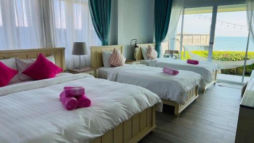 Postel nebo postele na pokoji v ubytování Sea Coco Resort