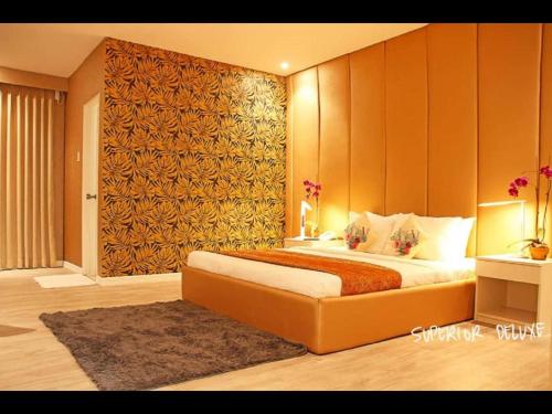 a bedroom with a large bed in a room at The Hotel Sophia in Cauayan City
