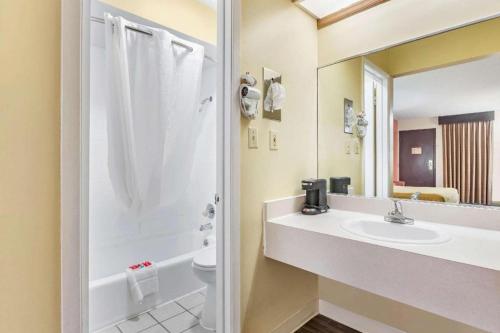 a bathroom with a sink and a shower and a toilet at Econo Lodge Urbandale - Northwest Des Moines in Urbandale