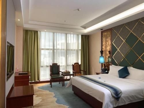 a hotel room with a bed and a large window at Shenzhen Kai Long International Hotel in Shenzhen