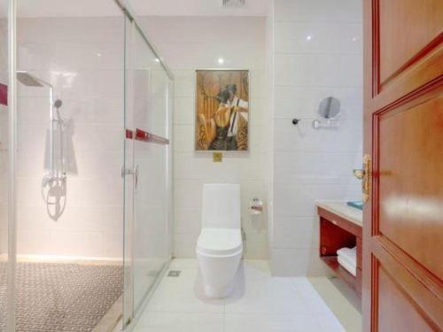 a bathroom with a toilet and a glass shower at Shenzhen Kai Long International Hotel in Shenzhen