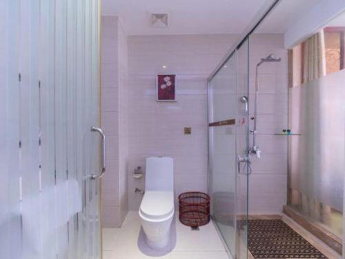 a bathroom with a toilet and a glass shower at Shenzhen Kai Long International Hotel in Shenzhen