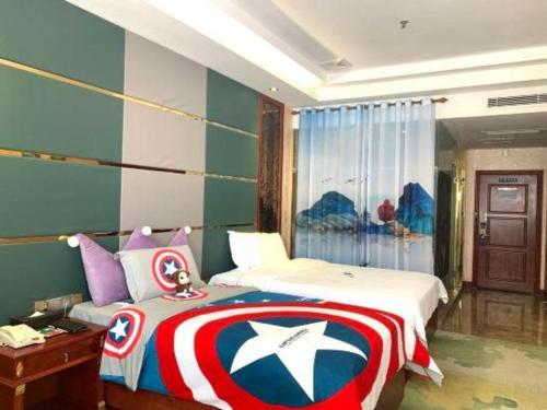 a bedroom with a captain america blanket on a bed at Shenzhen Kai Long International Hotel in Shenzhen