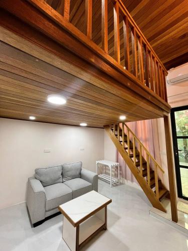 a living room with a couch and a staircase at Home In Dhigurah in Dhigurah