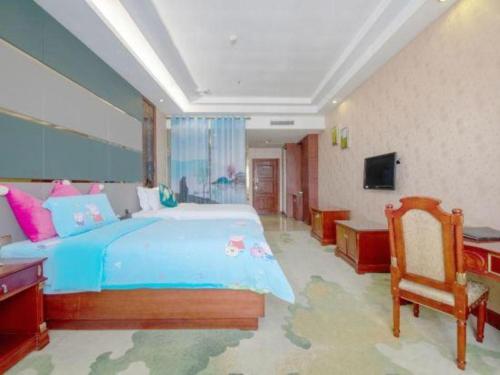 a bedroom with a large blue bed and a chair at Shenzhen Kai Long International Hotel in Shenzhen