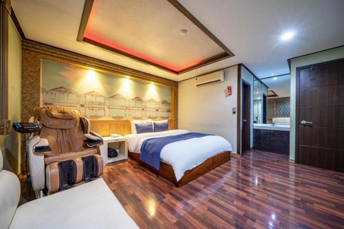a hotel room with a bed and a bathroom at SKY Hotel in Changwon